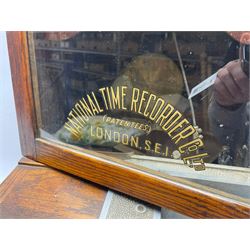Early 20th century oak cased time recorder, circular Roman dial signed 'Time Recorders Leeds Ltd. Park Lane & Oxford Row Leeds', the glazed door signed 'National Time Recorder Co Ltd. London...'