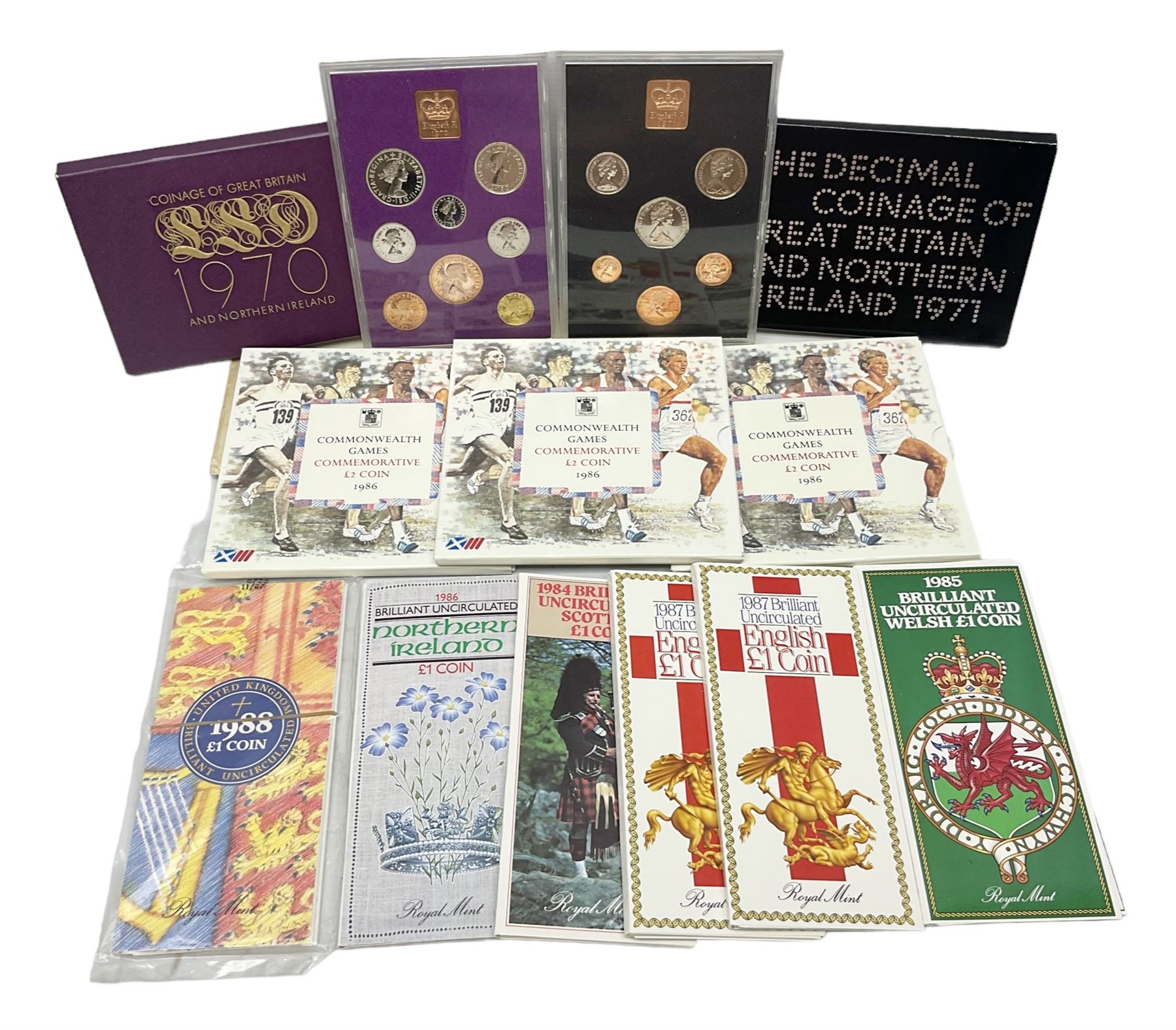 Two Great Britain and Northern Island proof sets dated 1970 and 1971, both with card cases, three 1986 Commonwealth Games commemorative two pound coins, in card folders, and six brilliant uncirculated one pound coins, in card folders
