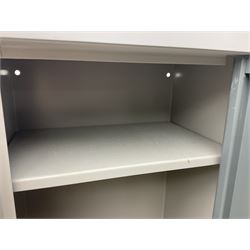Two-tone grey steel wall-mounting gun cabinet by Sambell Engineering to accommodate six guns with fixed shelf over, gun space int. H132cm W36.5cm D23.5cm, the single double-locking door with two sets of keys, ext. H154cm W37cm D27cm