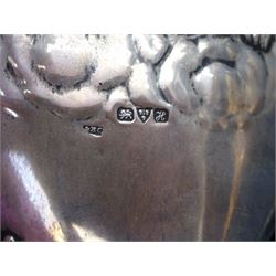 Four piece Edwardian silver mounted dressing table set, comprising hair brush, hand mirror, shoe horn and clothes brush, each embossed with cherubs, hallmarked Chester 1908, makers mark indistinct, together with a silver comb holder, hallmarked, contained within tooled leath, silk and velvet lined fitted case, 