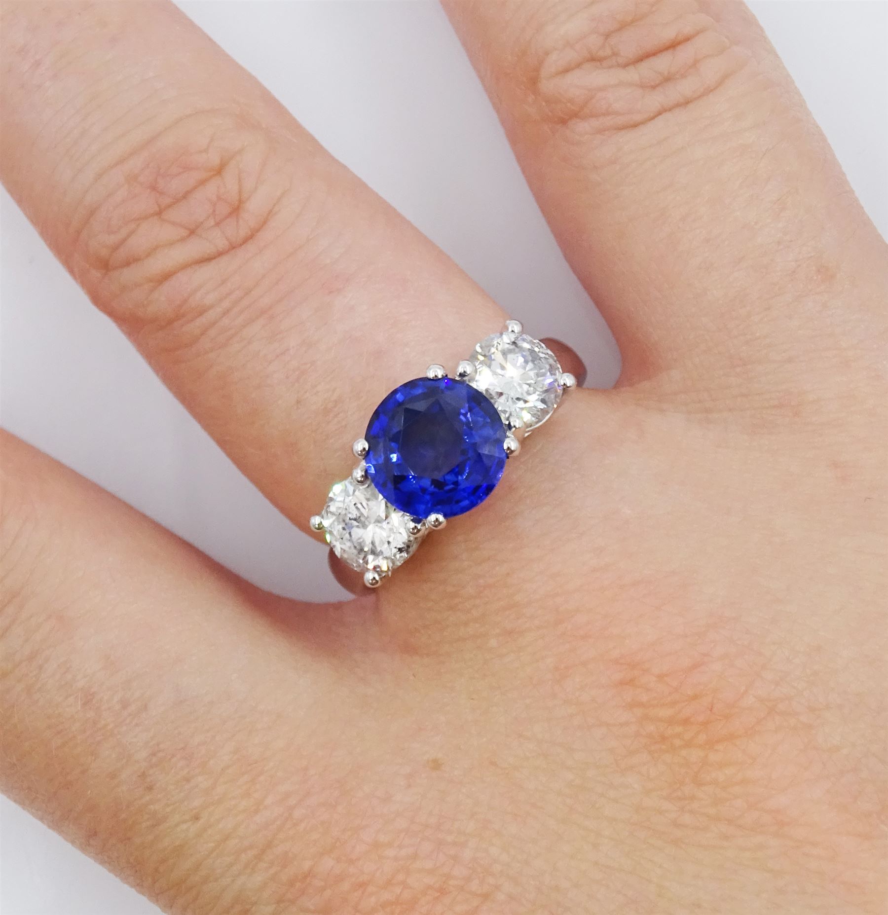 18ct white gold three stone sapphire and round brilliant cut diamond ring, hallmarked, sapphire approx 2.20 carat, total diamond weight approx 1.45 carat