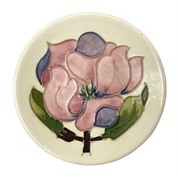 Moorcroft pin dish decorated in the Pink Magnolia pattern on a cream ground, D12cm