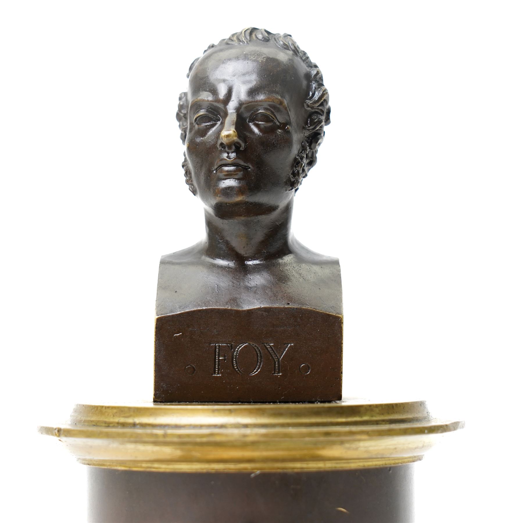 French 19th-century bronze inkwell surmounted by a bust of General Maximilien-Sébastien Foy, the cylindrical column applied with gilt-metal martial trophies and a classical caduceus of Hermes, emblematic of eloquence, commerce and diplomacy, raised on a brass socle cast with a scale pattern, on a square bronze base, the interior fitted with two glass inkwells and bronze pounce pot, H19cm
