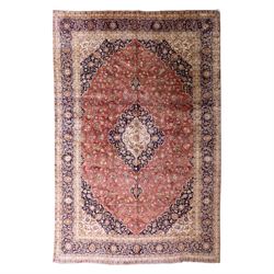 Large Central Persian Kashan hand-knotted carpet, madder red field with central cusped med...
