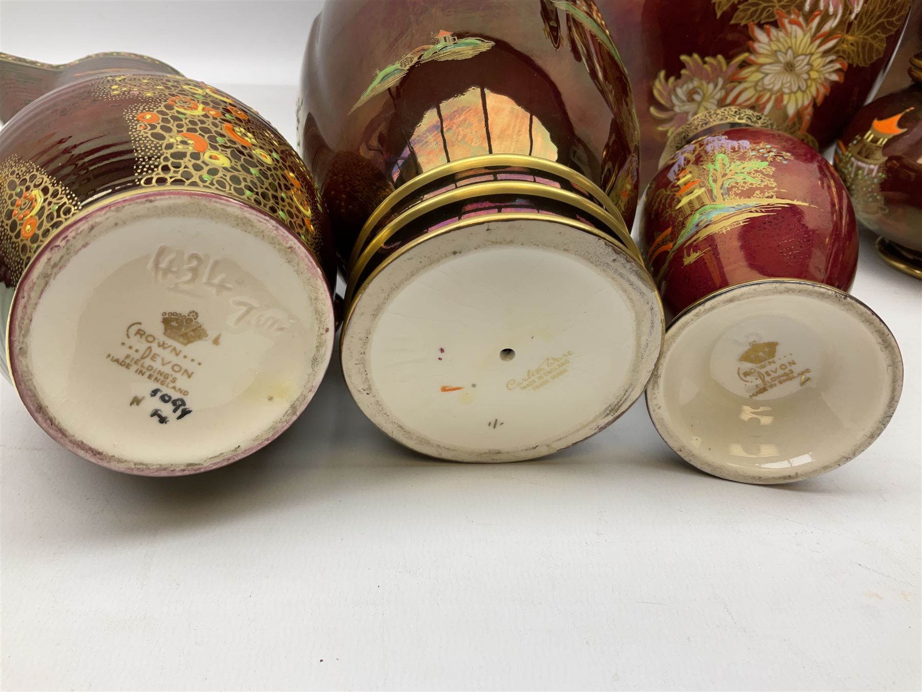 Two Crown Devon Rouge Royale pattern large temple jars with temple dog finial to lid, together with seven other Crown Devon ceramics and two lidded Carlton Ware temple jars in Red Royale, tallest example H47cm (11)