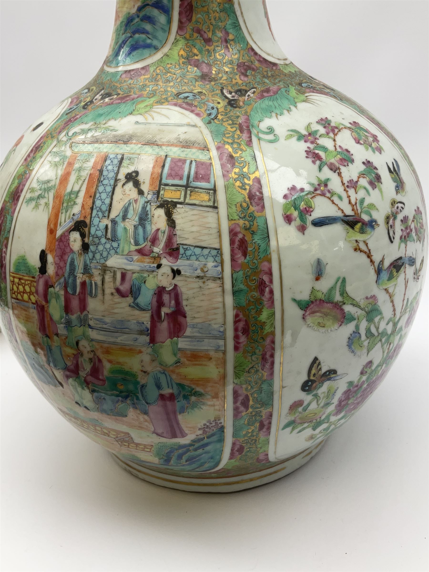 A 19th century Chinese Canton Famille Rose vase, of globular form with tall neck, and cover with finial, decorated with alternating panels of figural scenes, and birds and butterflies amongst blossoming and fruiting trees, with foliate surround against gilt, overall H57cm. 