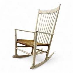 Mid-20th-century Scandinavian painted high-back rocking chair, curved top rail above slender spindle back, shaped arms with rounded ends above hand-woven rush seat, tapered rockers reinforced by turned stretchers 