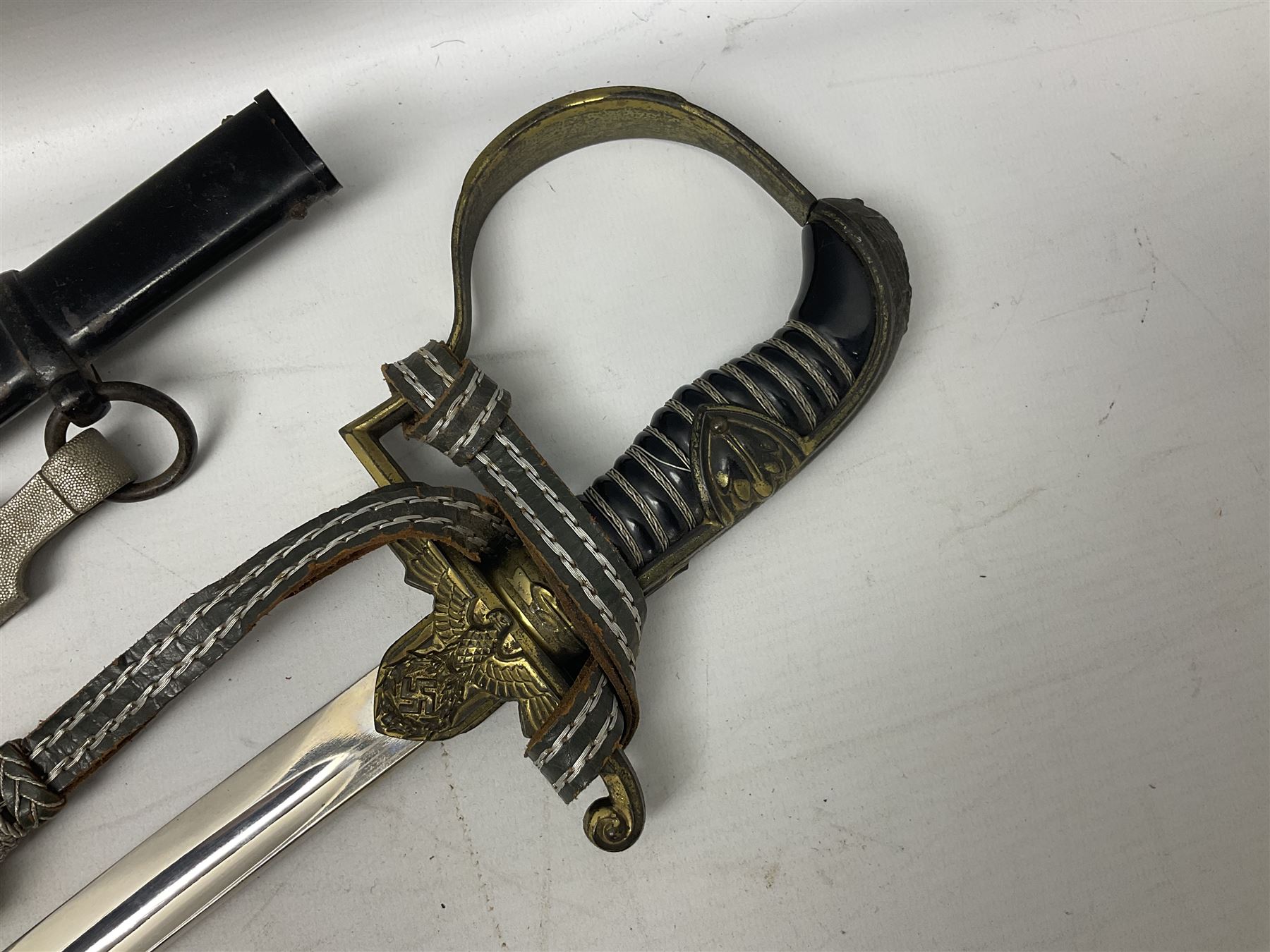 WW2 German Army Prinz Eugen Pattern Officers Dress Sword by Carl Eickhorn, the 80.5cm slightly curving fullered blade with makers name to the ricasso, gilt brass hilt with eagle to the cross-piece and relief of oakleaves to the ferrule, Prinz Eugen style down winged eagle to the pommel of the backstrap; grip retains the original wire binding; in original black painted scabbard with single hanging ring, leather hanger marked 'RZM M5/71 OLC' and silvered knot L97cm overall