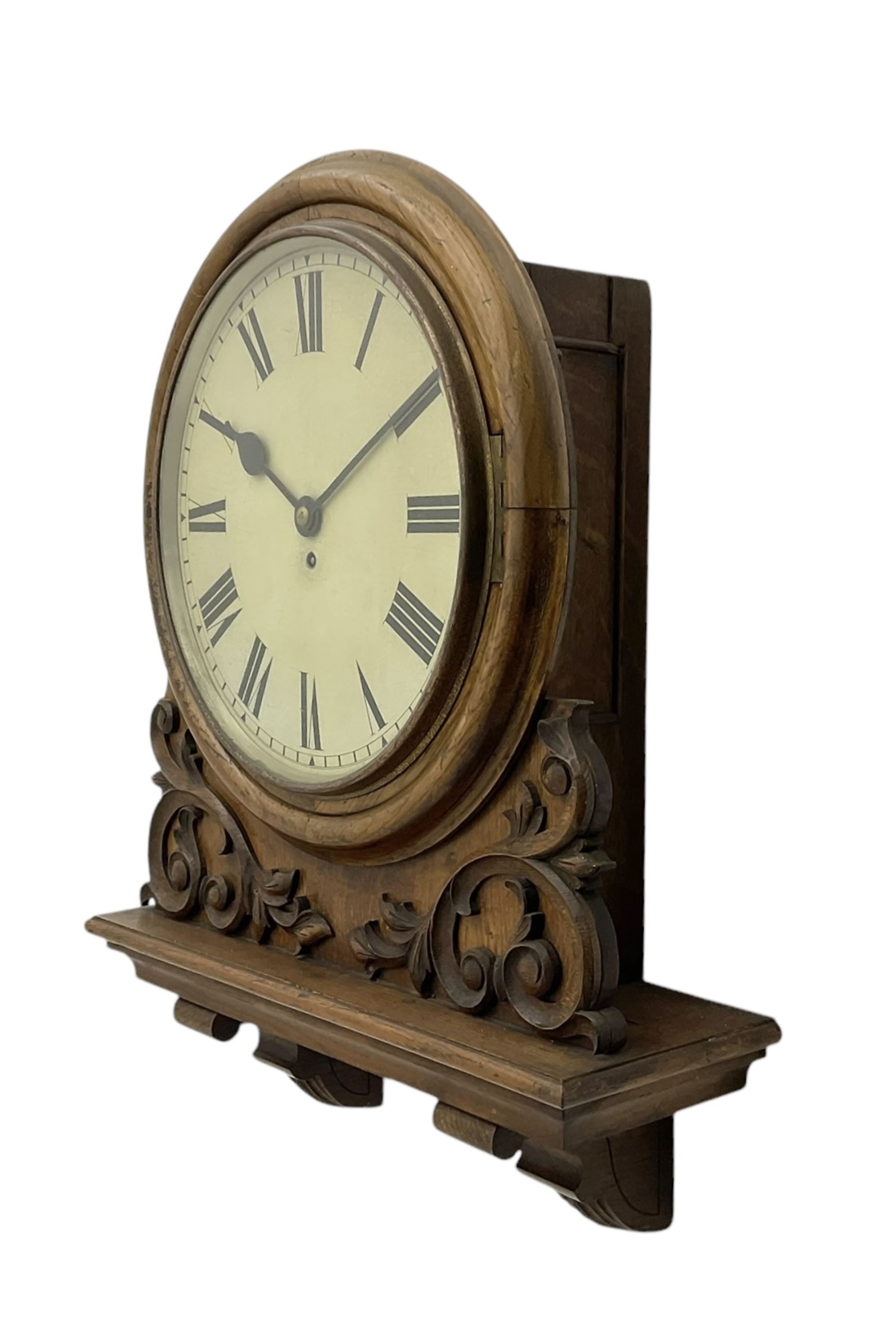 Winterhalter and Hoffmeier -  German oak cased early 20th century fusee wall clock, with a circular wooden surround and a spun brass glazed bezel to the dial, housed on an integral carved bracket with shaped corbel supports, painted dial with Roman numerals, minute track and steel spade hands, dial pinned directly to a four pillar chain driven fusee movement with a recoil anchor escapement. With pendulum and key. 
German fusee movements by Winterhalter and Hoffmeier are comparatively rare, especially housed in carved wall clocks of this description. 