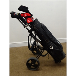  Set of 'TaylorMade' golf irons, putters, woods with matching bag and a trolley  