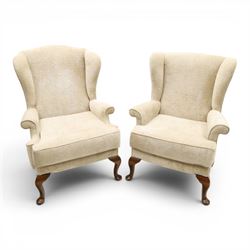 Parker Knoll - 'Hartley' lounge suite, comprising three wingback armchairs and two-seat settee, upholstered in cream fabric, shaped wing backs with scroll-over arms and loose seat cushions, on cabriole supports with pad feet wingbacks and settee

Armchairs: H 96cm, D 83cm, W 75cm