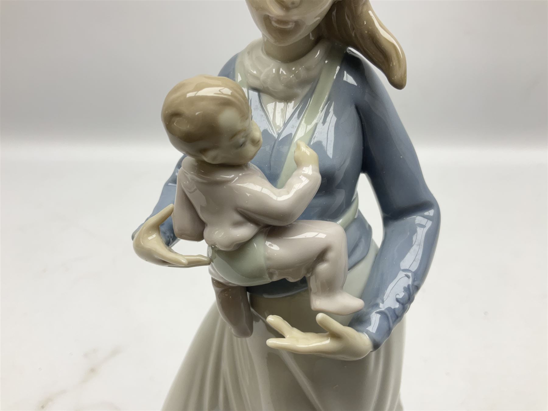 Three Lladro figures, comprising Modern Mother no 5873, Dropping the Flowers no 1285 and On the Beach no 1481, all with original boxes, largest example H30cm