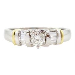 Platinum and 18ct gold single stone round brilliant cut diamond ring, with three baguette cut diamonds set each side, London 2016, total diamond weight approx 0.45 carat