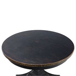 Contemporary circular painted dining table and four red upholstered chairs, table with distressed finish in black with quatriform base and bronze painted edges, chairs with 