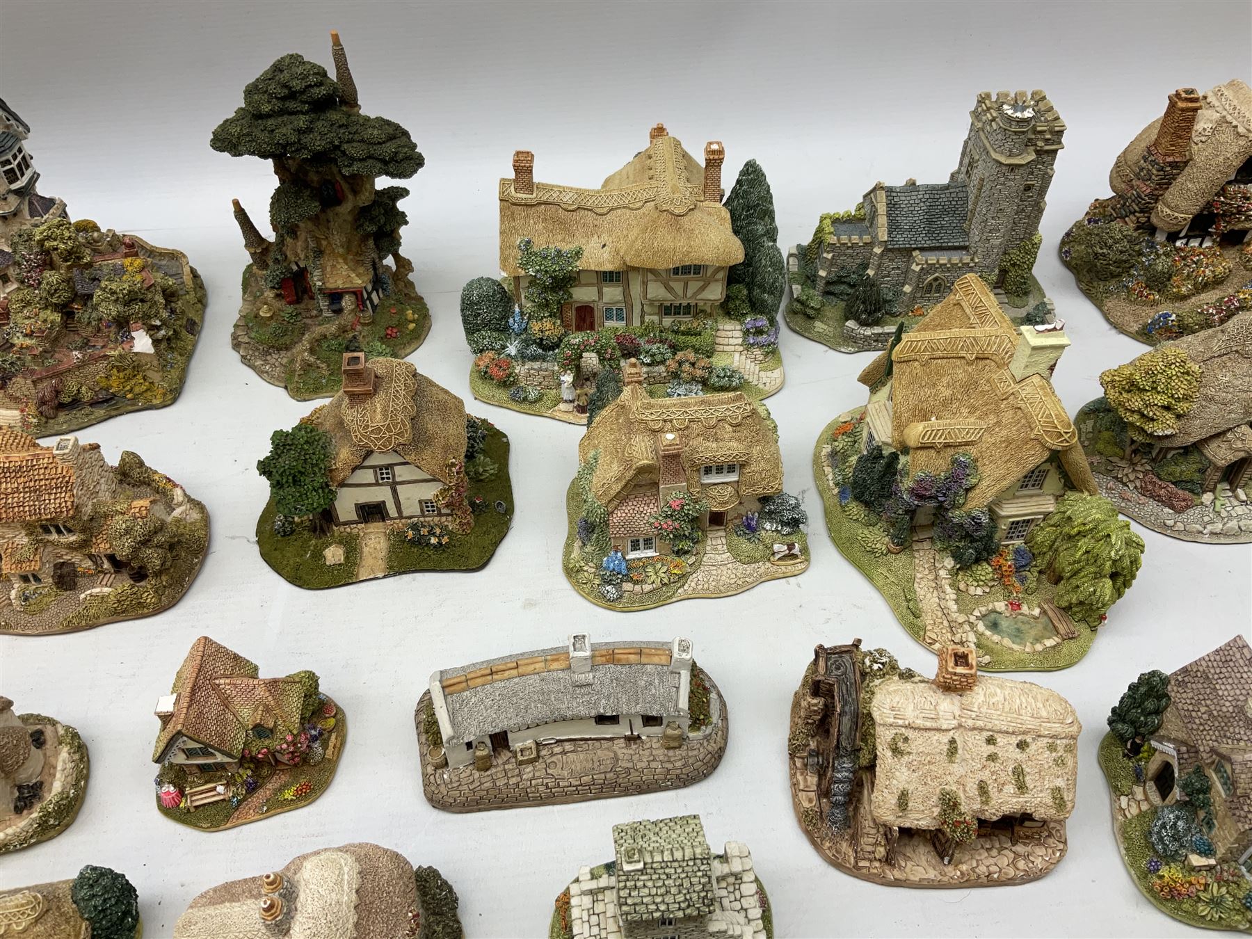 Forty six Lilliput Lane model cottages, to include 'Convent in the Woods', 'Holme Dyke' 'Secret Garden' etc