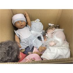 Two decorative wicker dolls prams, one with lace parasol,  and eleven dolls, including Leonardo Collection porcelain dolls, tallest pram including parasol H105cm