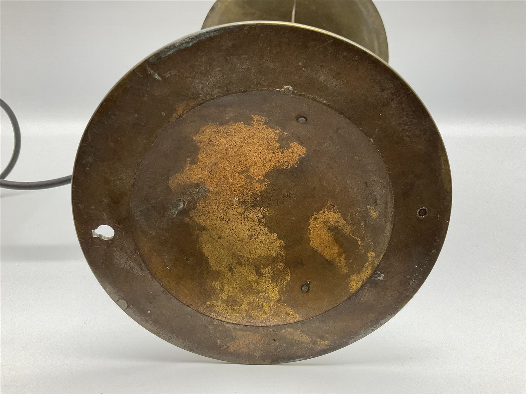 Arts & Crafts Jesson, Birkett & Co, brass table lamp or wall light, designed by Thomas Birkett, the tapering stem with adjustable ball pivot supporting a conical shade with tapering final with ball terminal, upon a circular domed base pierced for wall mounting, shade positioned upright overall H57cm

Often misattributed to Arthur Stansfield Dixon for Birmingham Guild of Handicraft, this particular lamp was designed by Thomas Birkett.
In the late 1890's Birkett worked as a metalwork at the Birmingham Guild, before later joining the Faulkner Bronze Company which went on to become Jesson, Birkett & Co in 1904. The lamp features in lighting catalogues from the firm under the model no E490.

