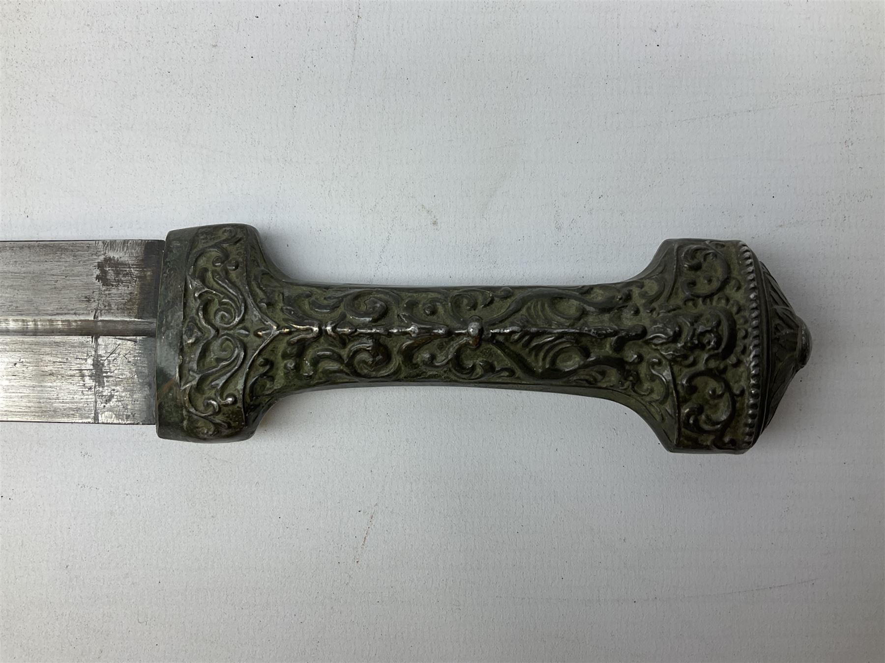19th century Khanjali dagger, 33.5 cm double edged fullered blade with stamped makers marks, ornate cast grip, with engraved white metal scabbard, 46cm overall