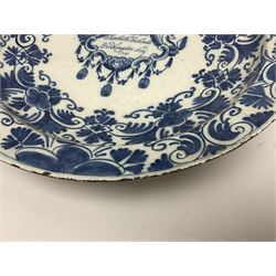 Early 18th century Delft marriage plate, of circular form with dished centre, the centre inscribed and dated 'Thomas and Elizabeth Kockerill Bridlington Key 1715' within a crowned C scroll cartouche, flanked by demi-griffins, above a putto head and tassels, within a wide foliate border, D34cm
