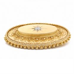 19th / early 20th century gold Etruscan Revival oval brooch, set with a single old cut diamond of approx 0.20 carat, surrounded by wirework and bead decoration, stamped 15ct