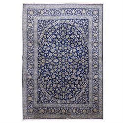 Central Persian Kashan hand-knotted carpet, deep indigo blue field densely decorated with ...