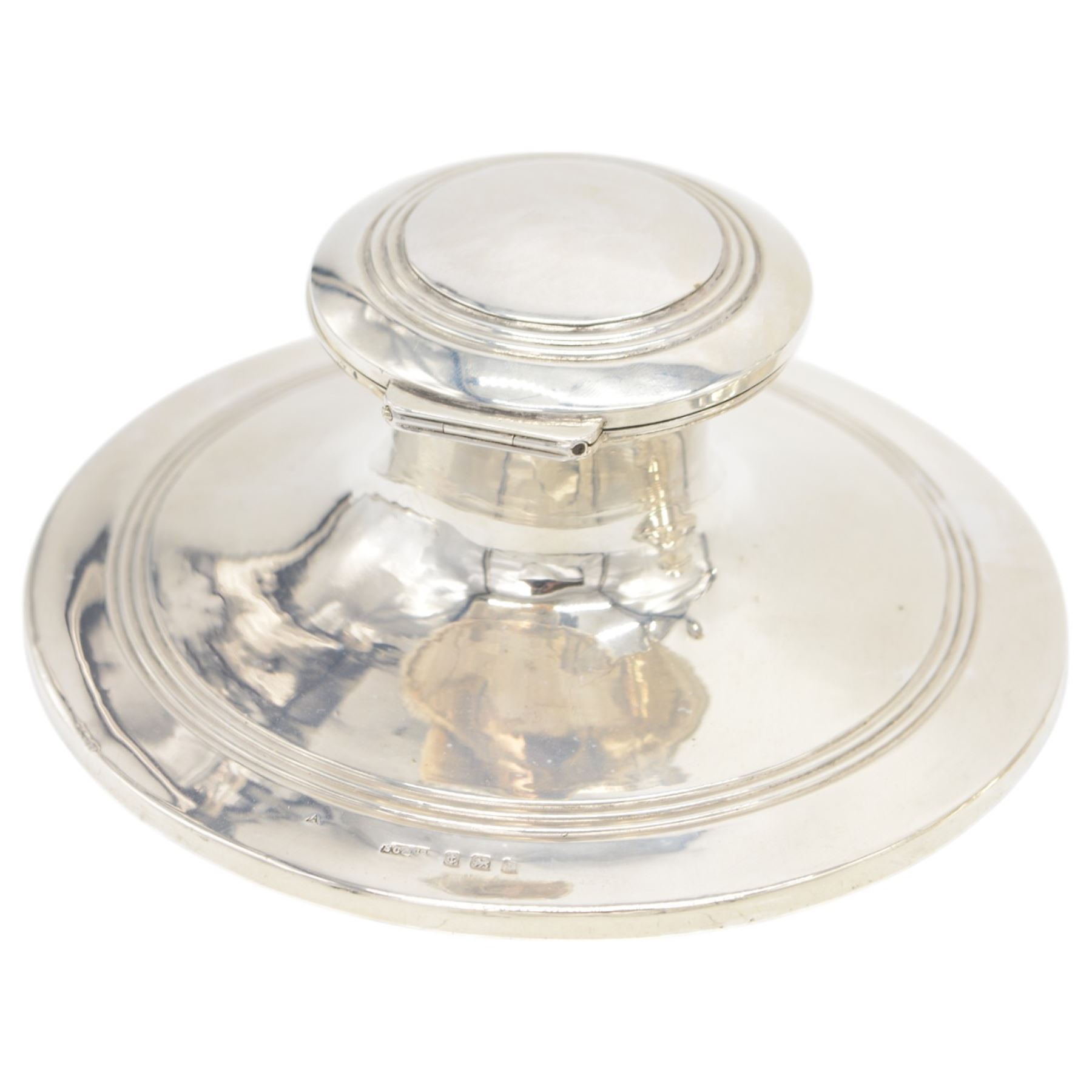 Two early 20th century silver mounted capstan inkwells, both of typical form, the first example hallmarked Wilmot Manufacturing Co, Birmingham 1918, the second example hallmarked Spooner Clowes & Co, Birmingham 1908, largest D15cm, H9.5cm