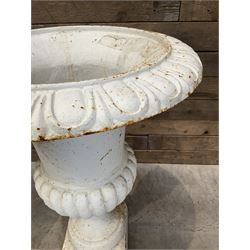 Pair of large Victorian design white painted cast iron campana shaped garden urns, egg and dart rim over a gadrooned underlobe, tapering column on square plinth base