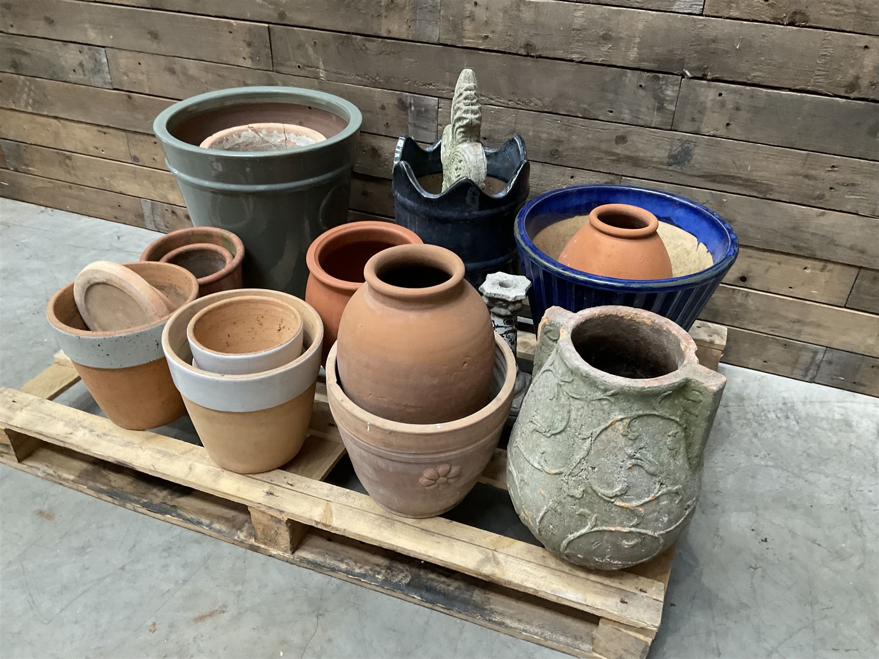 A quantity of various terracotta and glazed planters