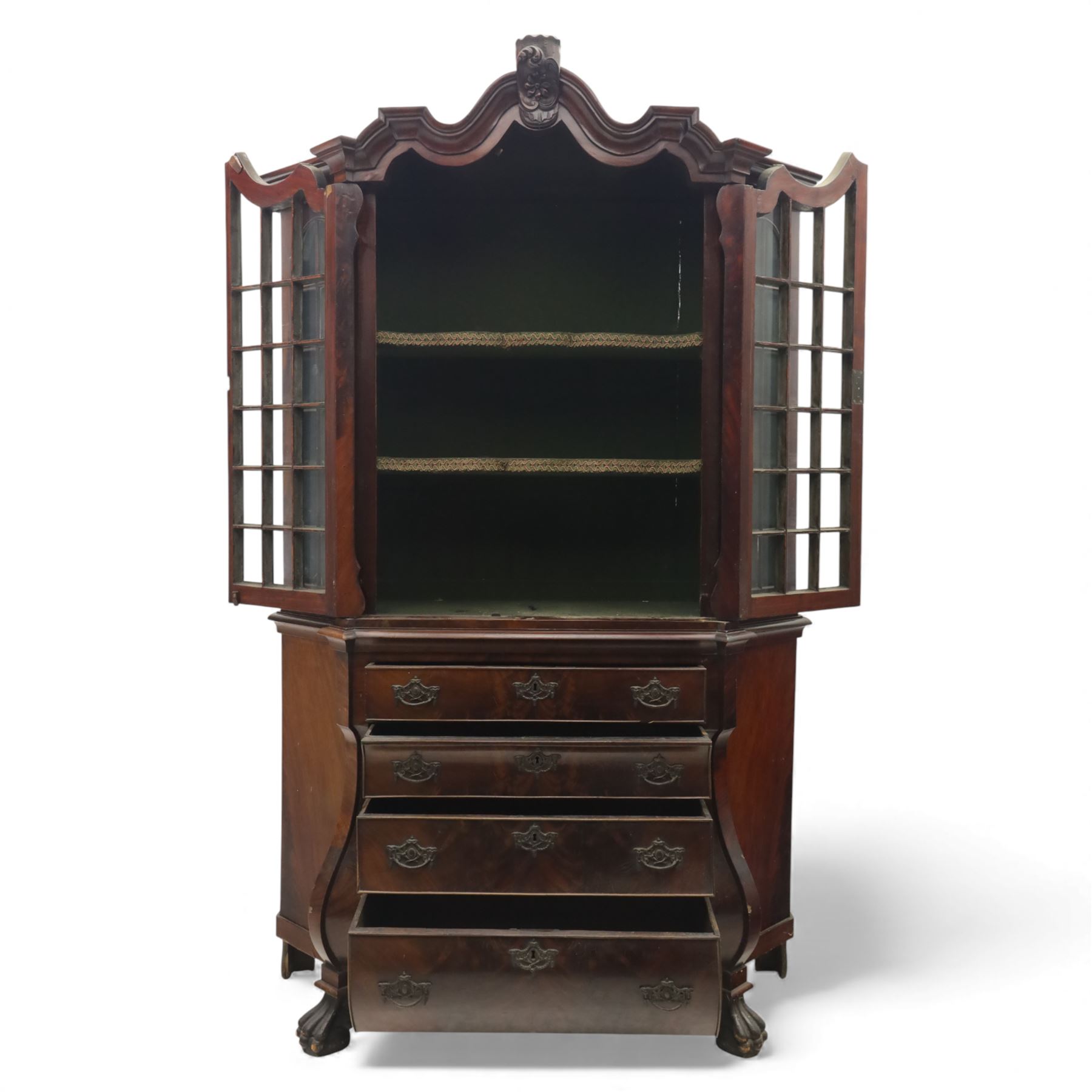 Late 19th century Continental bombe cabinet on chest, shaped moulded cornice with carved cresting, the upper section enclosed by a pair of arched glazed doors with astragal glazing revealing a shelved interior, the lower section fitted with four graduating drawers with rococo-style metal handles, serpentine front and sides, raised on scroll and paw feet