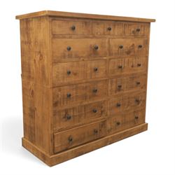 Indigo Furniture - large rustic oak combination chest, three drawers above ten drawers, with blackened pulls, raised on a plinth base