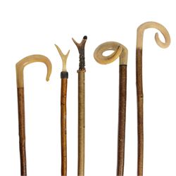 Five walking sticks, comprising two antler hafted thumb sticks, tallest approximately 128c...