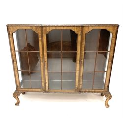 Mid 20th century mahogany triple display cabinet, carved edging, three glazed doors enclosing glass shelving, raised on acanthus carved cabriole supports 