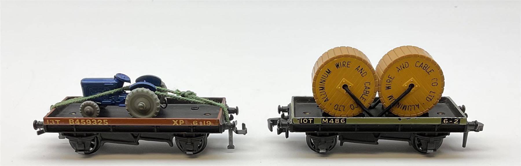 Hornby Dublo - 4646 Low-Sided Wagon D1 with cable drums; 4649 Low-Sided Wagon with tractor; 4656 16-Ton Mineral Wagon brown; 4657 United Dairies Milk Tank Wagon; 4660 U.G.B. Sand Wagon; 4677 Tank Wagon 'Mobil' (D1); and 4680 Tank Wagon 'Esso' (Fuel Oil); all boxed (7)