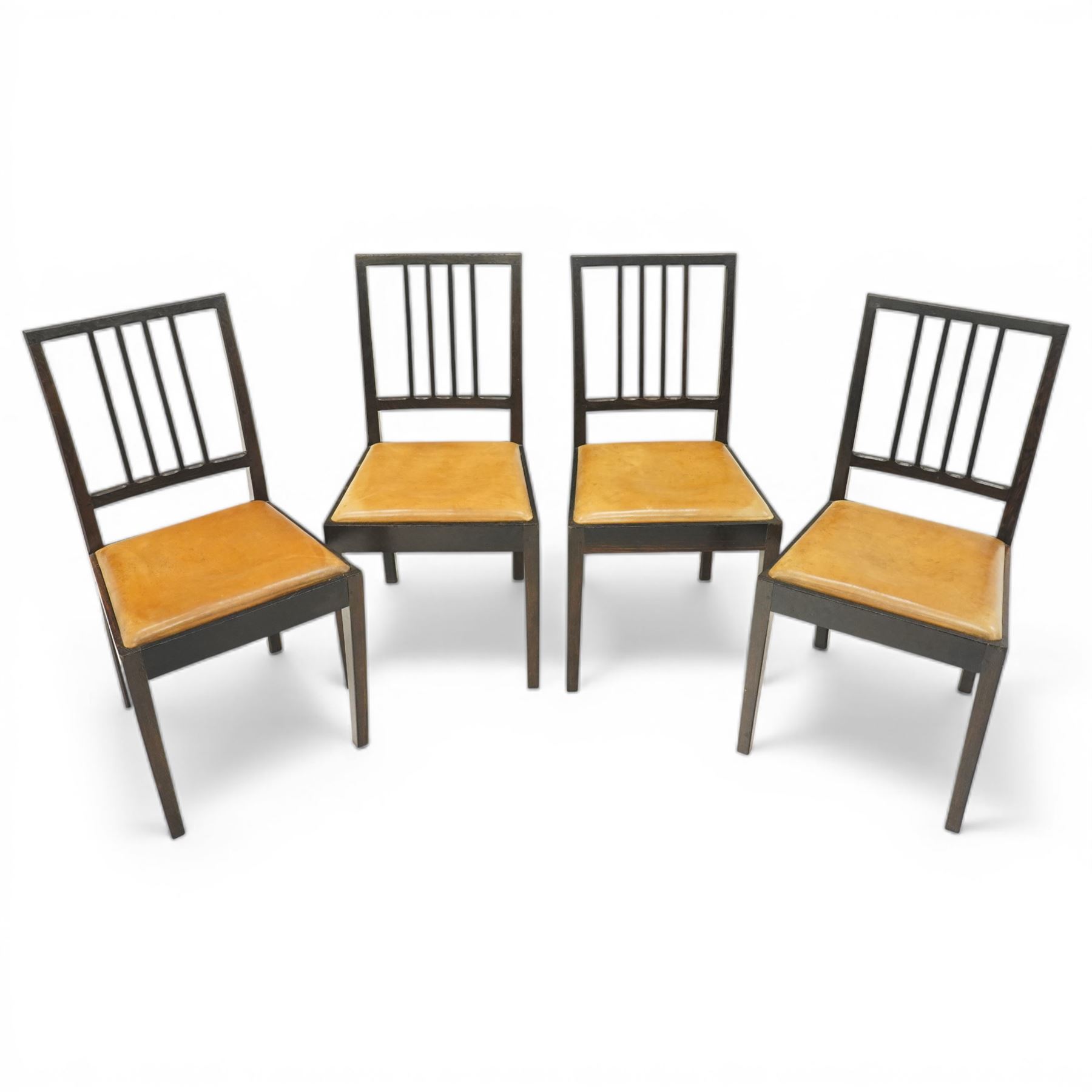 Acornman - set of four dark stained oak dining chairs, with four vertical slats, drop-in tan leather seat, supported on square tapering legs with carved acorn signature, by the workshop of Alan Grainger of Brandsby