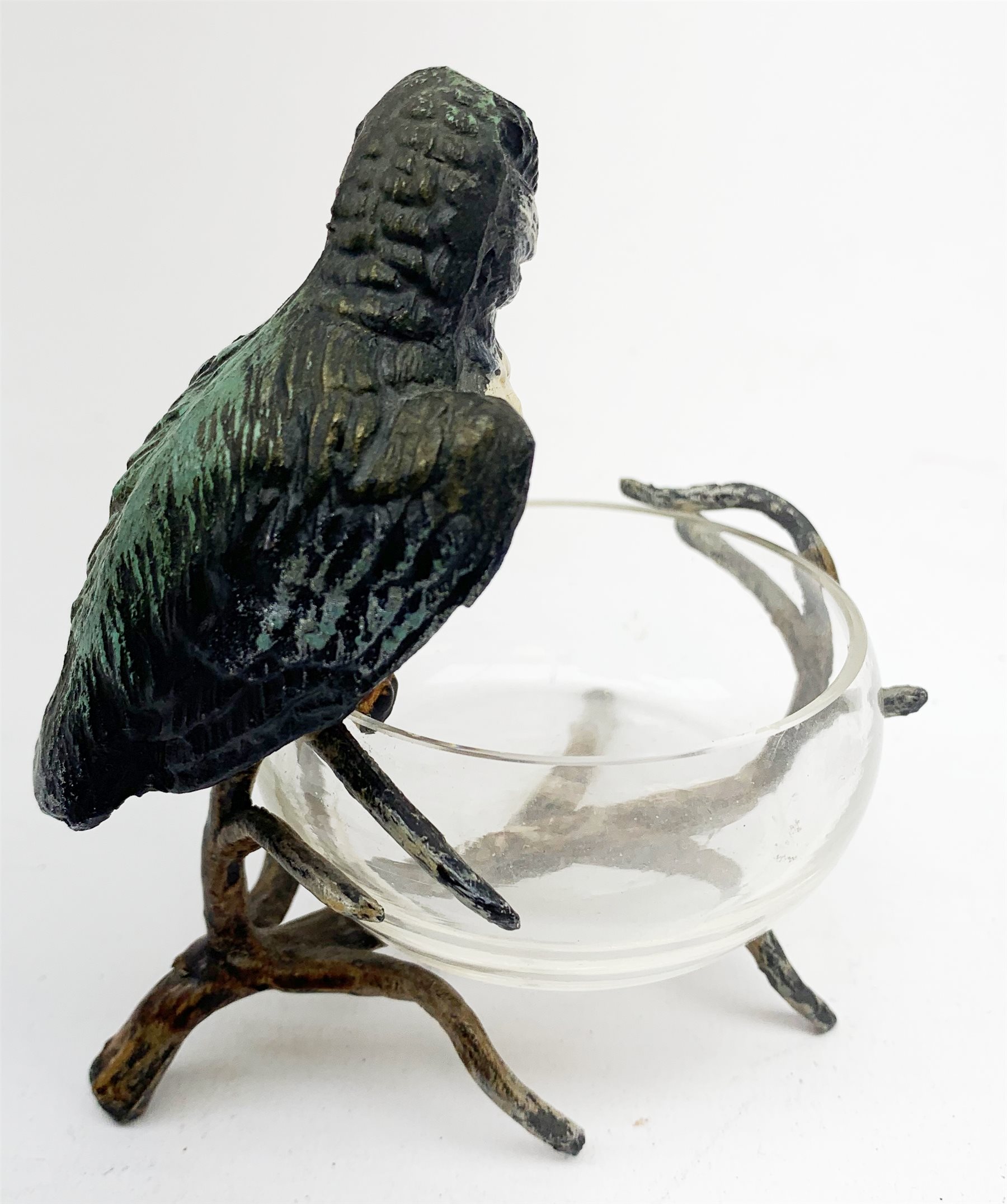 A cold painted model of a Kingfisher surmounted upon a branch surporting a small clear glass bowl, H10.5cm, together with a small bronze model of a penguin, stamped EWB, H7cm. 