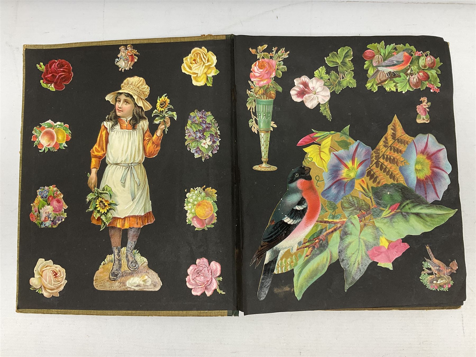 Victorian scrapbook containing twenty-six double sided pages and two fixed end pages of various fixed decoupage to include clippings of maritime interest, greeting cards, portraiture, flowers, animals etc, 