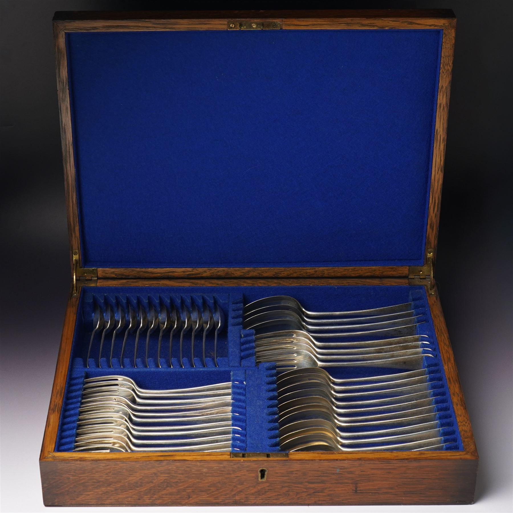  Canteen of silver cutlery comprising twelve dessert spoons, twelve dessert forks, twelve teaspoons, four table spoons and four table forks in oak case London 1938 Maker Josiah Williams & Co