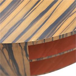 Toby Winteringham - Mid 20th century zebra wood coffee table, oval top with book matched striped veneers over two open tiers painted red, the curved end supports and continuous plinth base veneered to match, recessed plinth base 