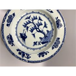 Three late 18th/early 19th century Chinese export dishes, of circular form decorated with central panel of plantain and bamboo within lattice and foliate borders, D23cm, together with two further dishes, the first example decorated with crane and tree, the second with blossoming flowers and fence, each D22.5cm