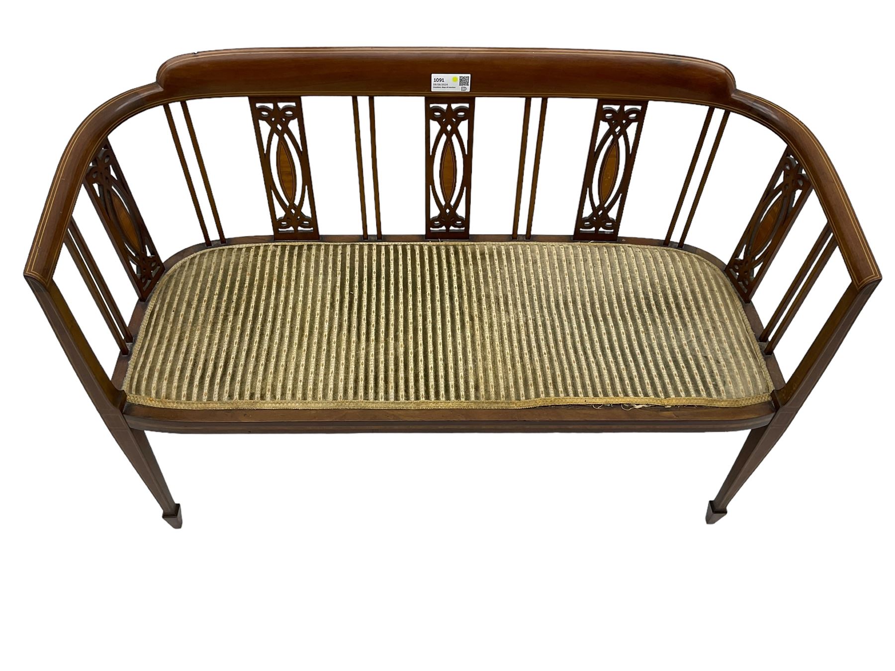 Edwardian inlaid mahogany two-seat salon sofa, curved back and arms inlaid with boxwood stringing, vertical slat back with pierced splats inlaid with satinwood, upholstered seat, on square tapering front supports with spade feet 