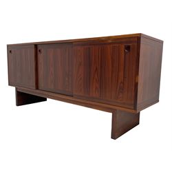 NH Chapman & Co Siesta - mid-20th century sideboard, fitted with three sliding doors, enclosing two drawers and shelves, raised on twin end supports