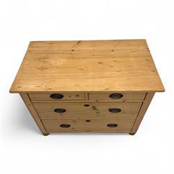 19th century pine chest of drawers, rectangular top over two short and two long drawers with oval pressed brass backplates and drop handles, panelled sides, rounded front edges, on compressed bun feet
