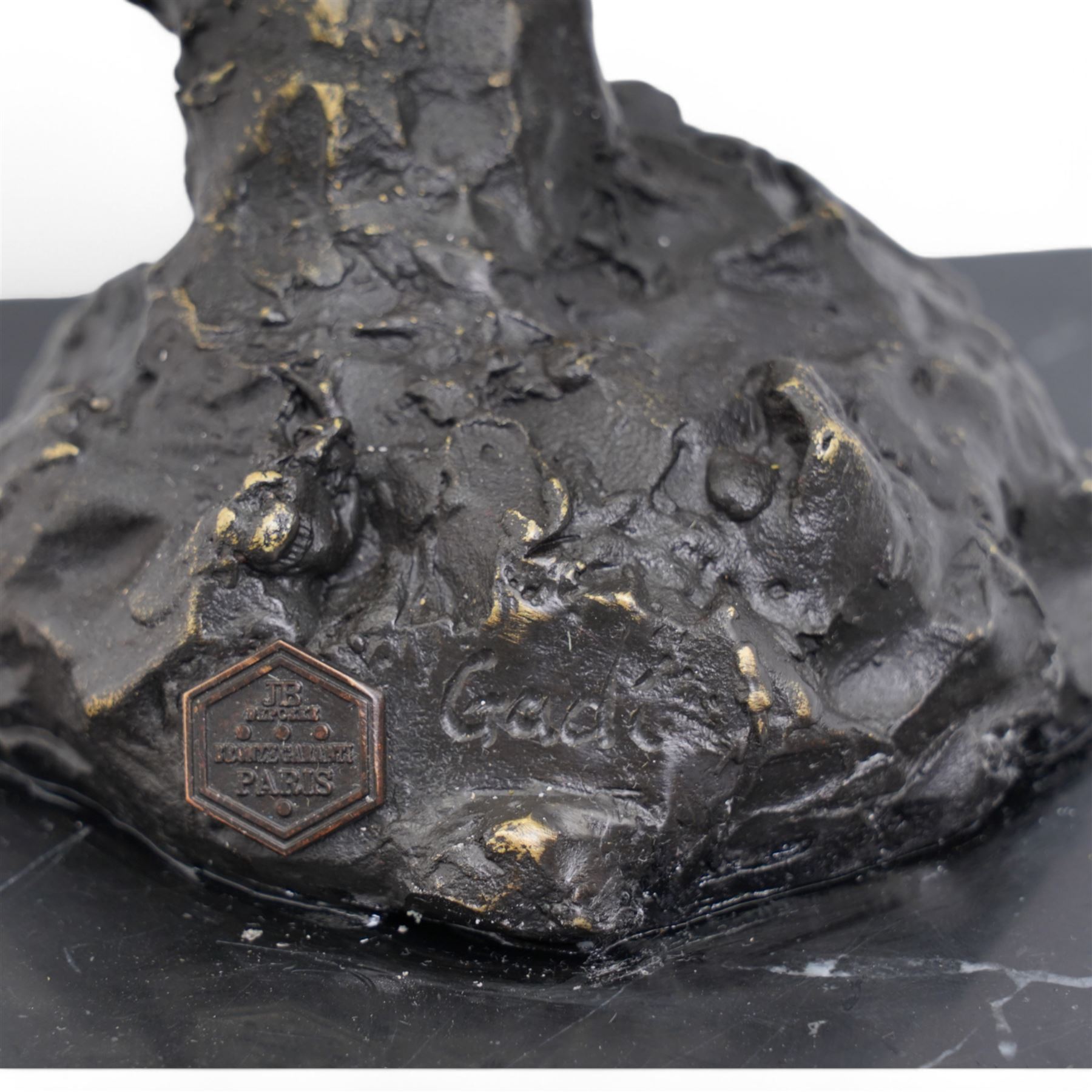 Bronze figure, modelled as a stylised horses head, upon a square marble plinth, signed and bearing foundry mark, overall H41cm