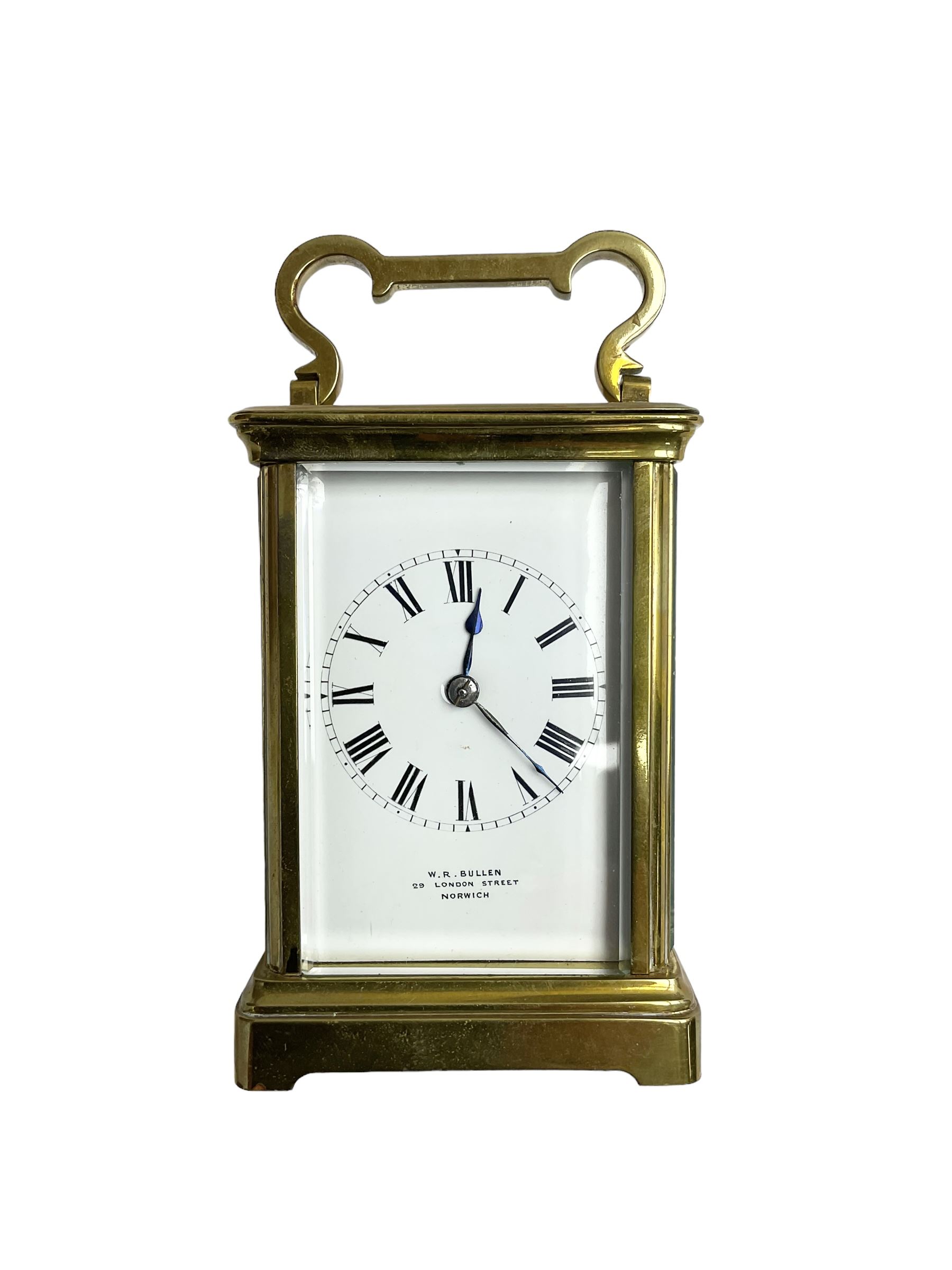 W.R. Cullen, London Street. Norwich. - 8-day French carriage clock c1900, in a corniche case with carrying handle and four bevelled glass panels, white enamel dial with Roman numerals, minute markers and spade hands, with a lever platform escapement and rack striking movement striking the hours and half hours on a coiled gong. 
