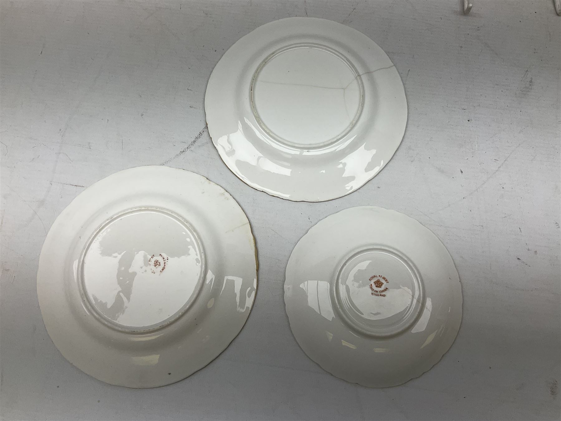 Quantity of Royal Albert tea wares to include 'Moss Rose' teapot, sucrier and saucers, together with teacups, saucers, side plates, jug etc decorated with orange, yellow and blue floral sprays with gilding upon plain ground, all stamped Royal Albert beneath