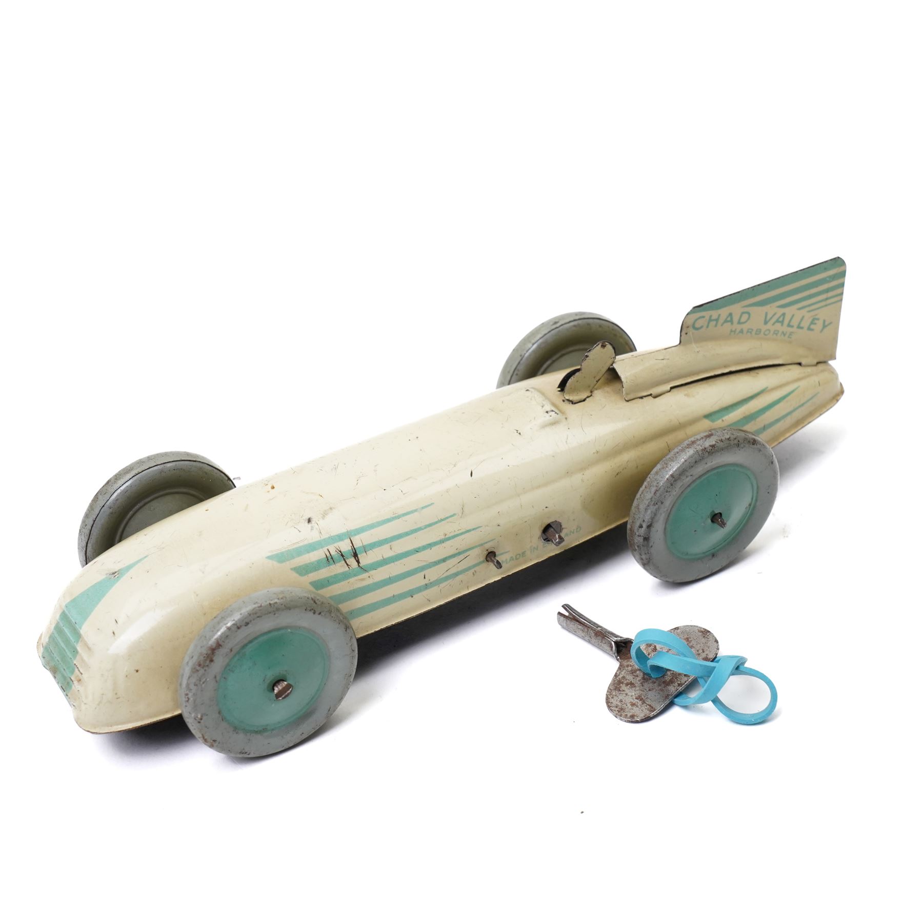 Chad Valley Harborne tin plate and clockwork racing car, cream and green with matching green hubs, length 20cm