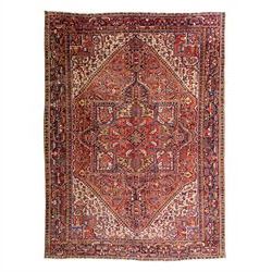North West Persian Heriz hand-knotted carpet, madder red field, with a large angular stepp...