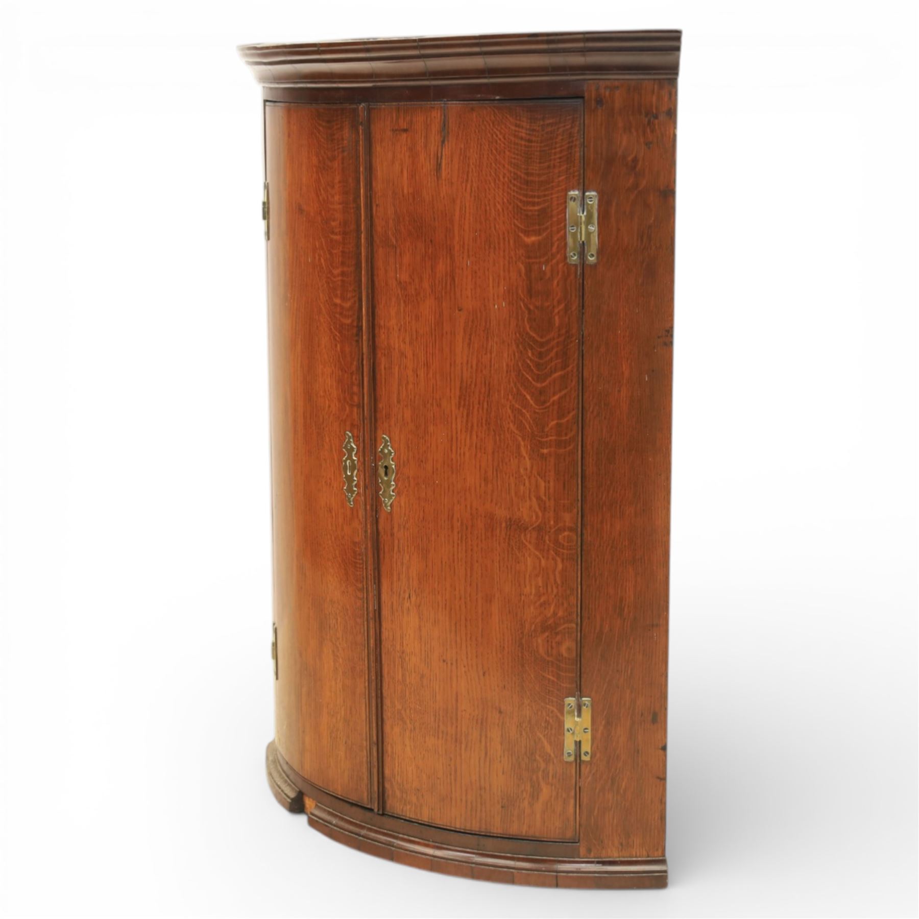 George III oak and mahogany wall hanging cylinder corner cupboard, moulded cavetto cornice over double cupboard enclosing three shelves
