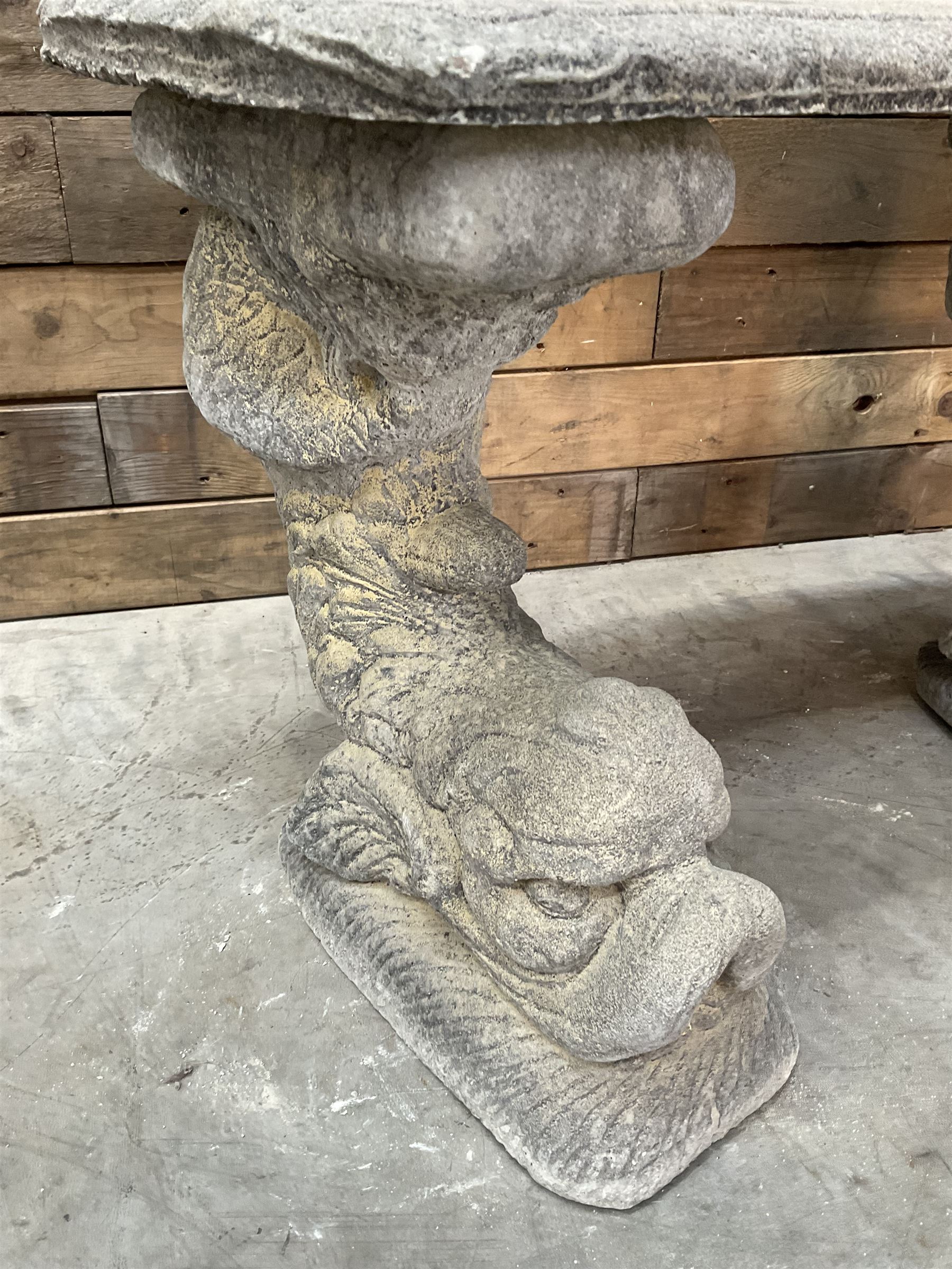 Cast stone four piece curved Dolphin bench, set with three dolphin pillars, curved rectangular slab top with detailed border