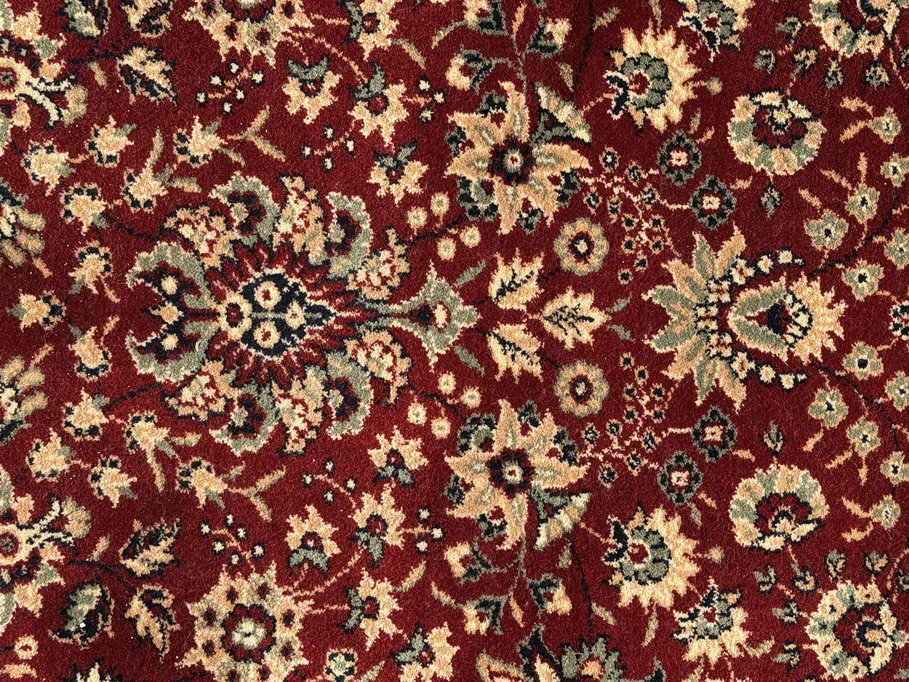 Royal Kashmir worsted wool modern Persian design area rug, with crimson field and stylised rosette patterning throughout, surrounded by wide multi-band border incorporating cartouche and lotus flower motifs